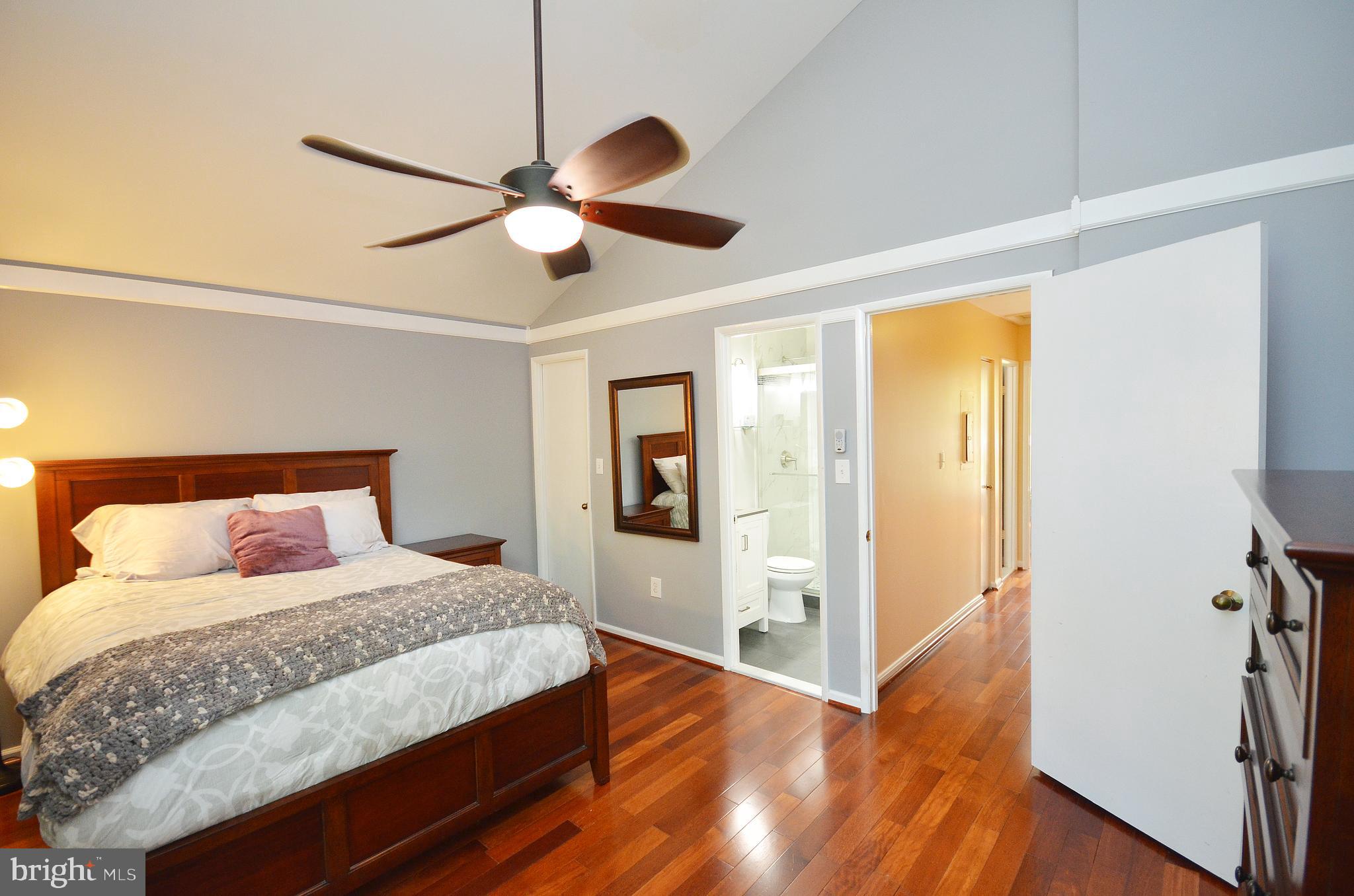 11214 Beaver Trail Court, Unit 12 Reston, VA 20191 - Photo 18 of 27 a bedroom with a bed and wooden floor