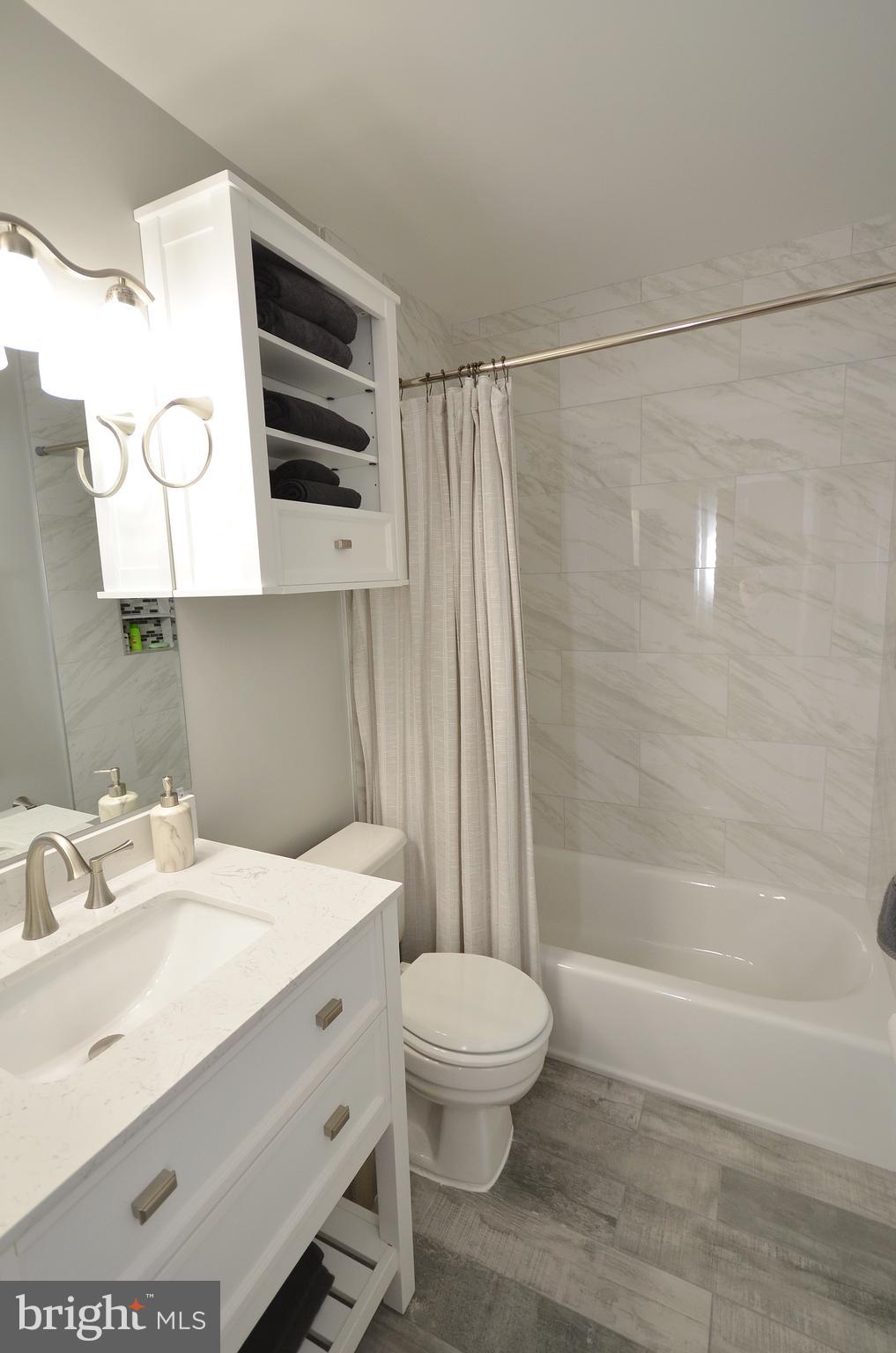 11214 Beaver Trail Court, Unit 12 Reston, VA 20191 - Photo 24 of 27 a bathroom with a sink a toilet and shower