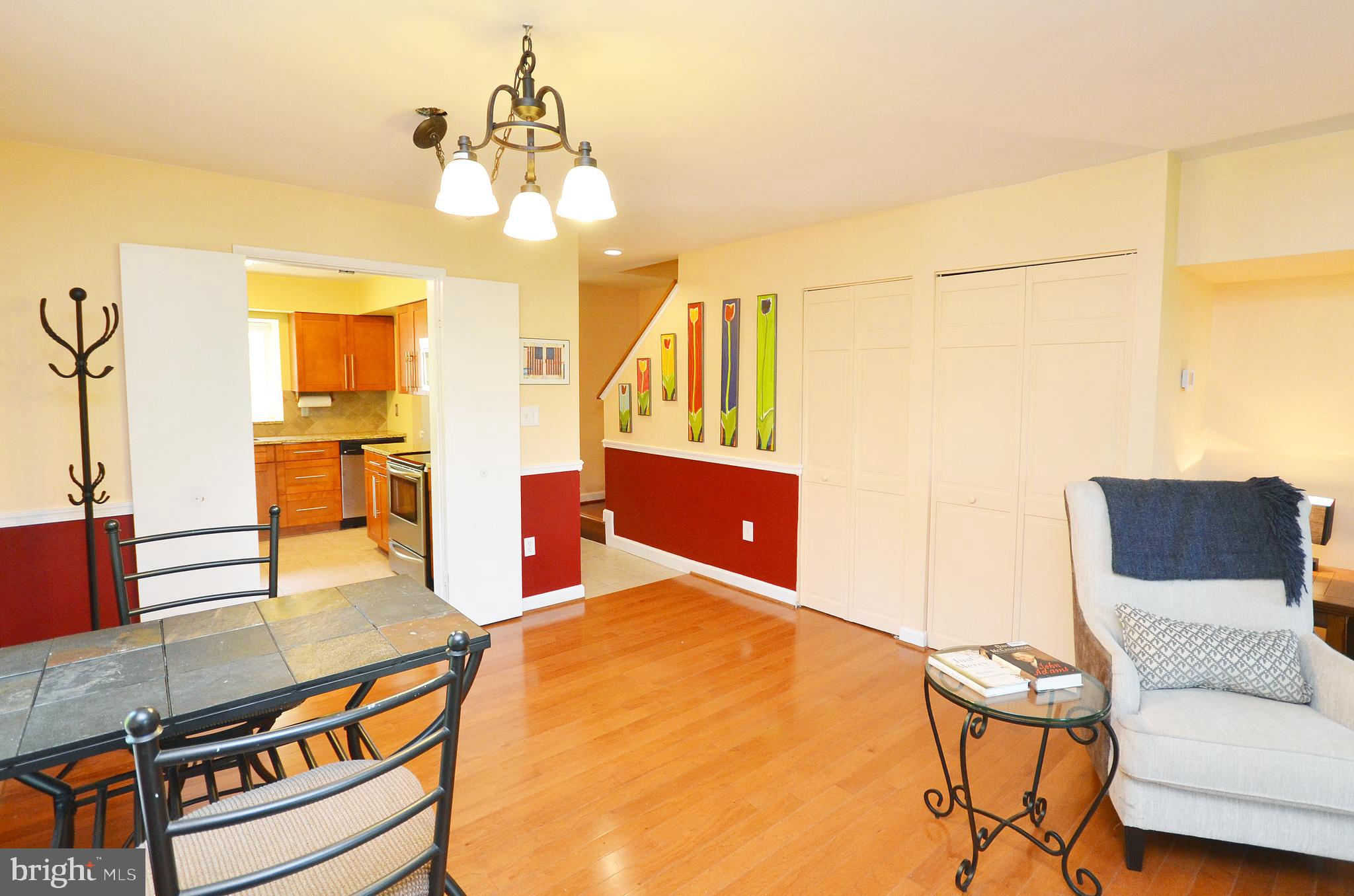 11214 Beaver Trail Court, Unit 12 Reston, VA 20191 - Photo 8 of 27 a living room with furniture and a chandelier