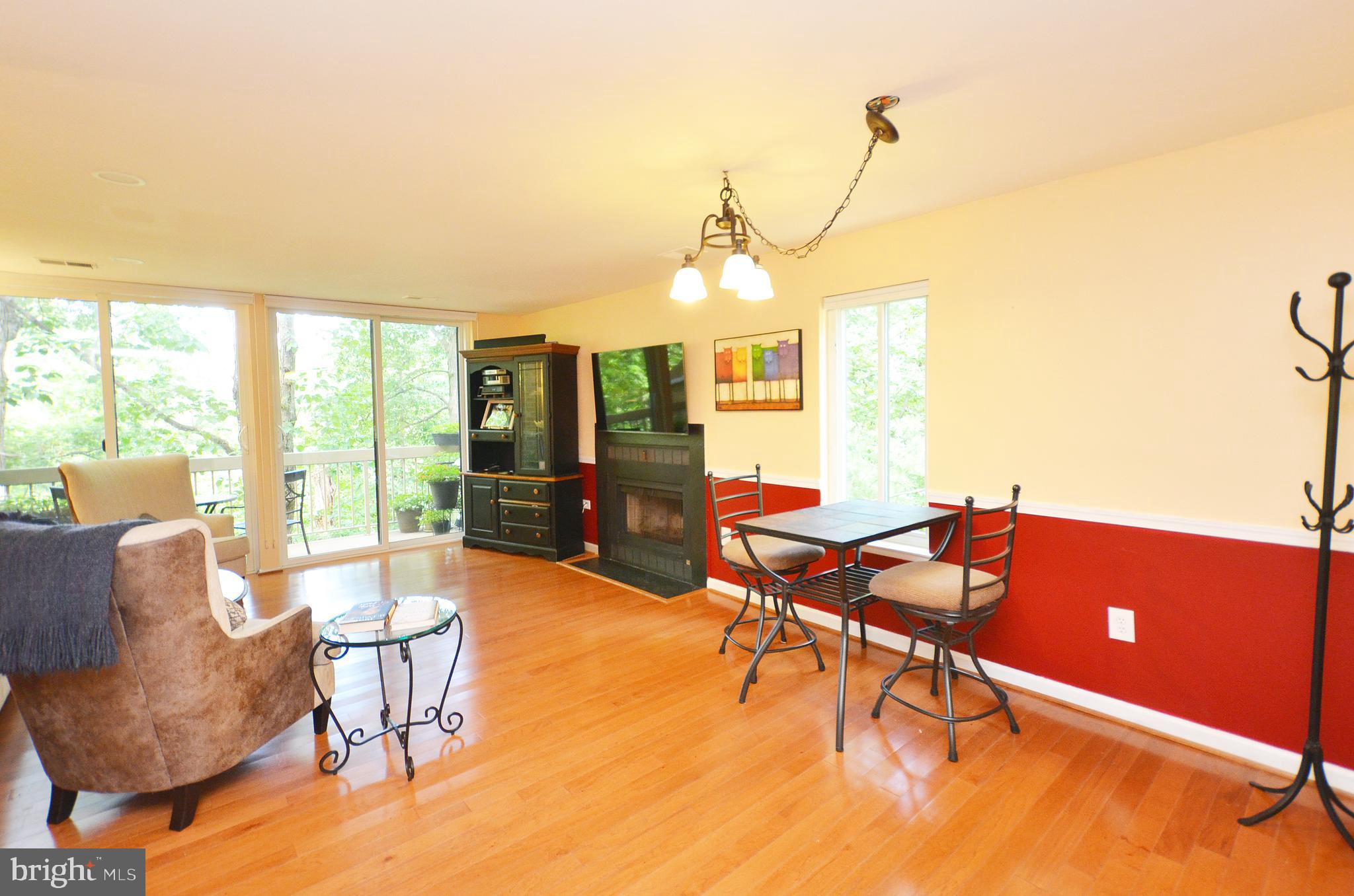 11214 Beaver Trail Court, Unit 12 Reston, VA 20191 - Photo 9 of 27 a living room with furniture a flat screen tv and a large window
