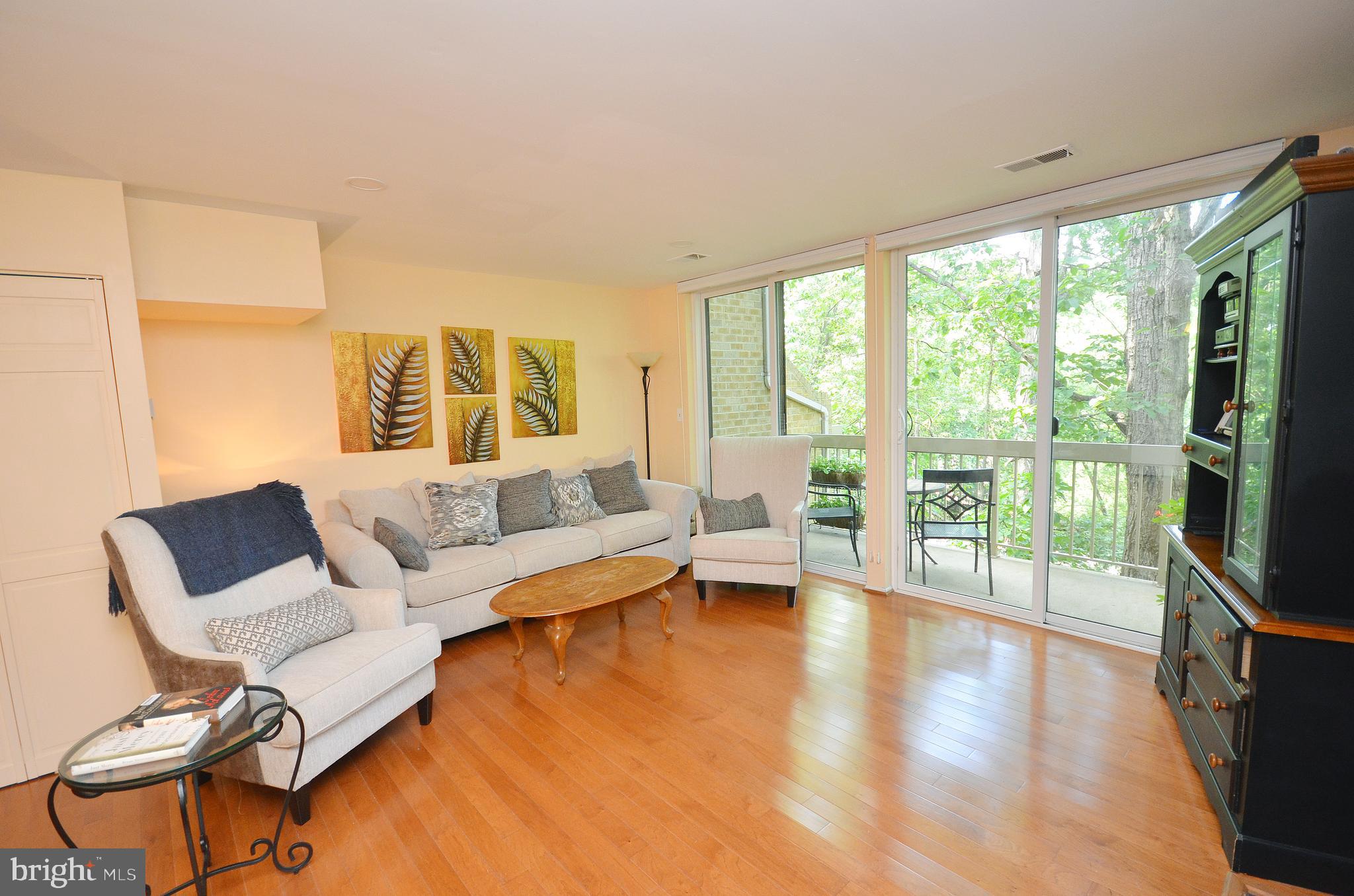 11214 Beaver Trail Court, Unit 12 Reston, VA 20191 - Photo 10 of 27 a living room with furniture and a large window