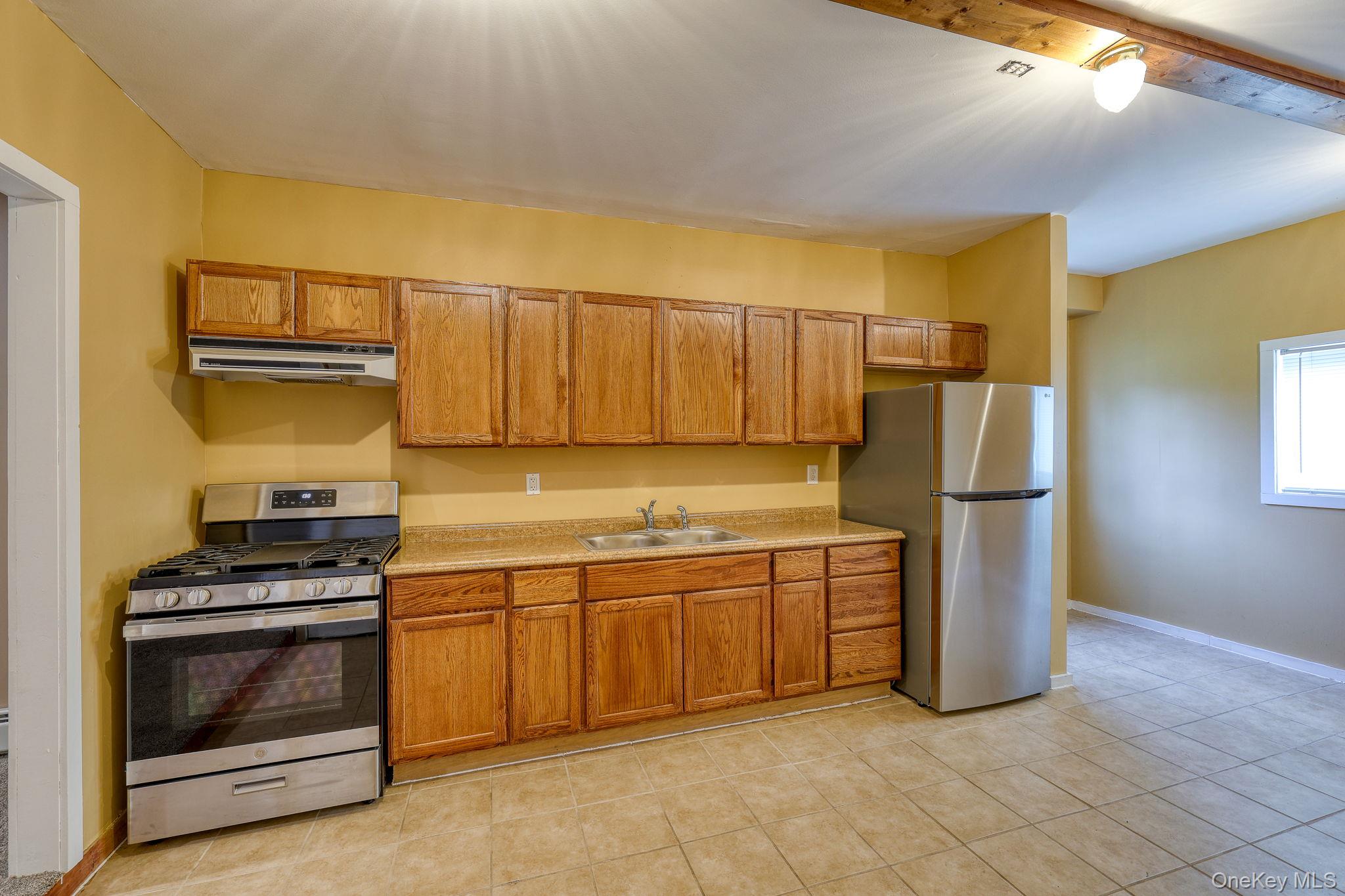 226 Big Woods Road Harris, NY 12742 - Photo 11 of 20 a kitchen with stainless steel appliances a stove a microwave and a refrigerator