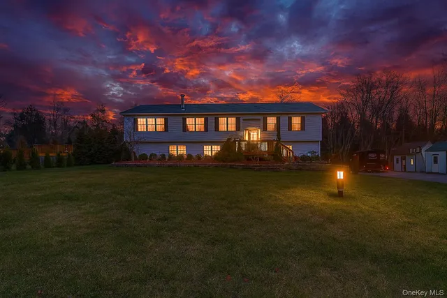 a front view of a house with a garden