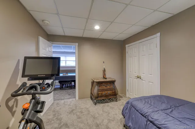 a bedroom with bed and a flat screen tv