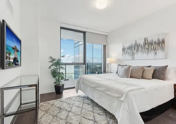 a bedroom with a bed and a flat screen tv