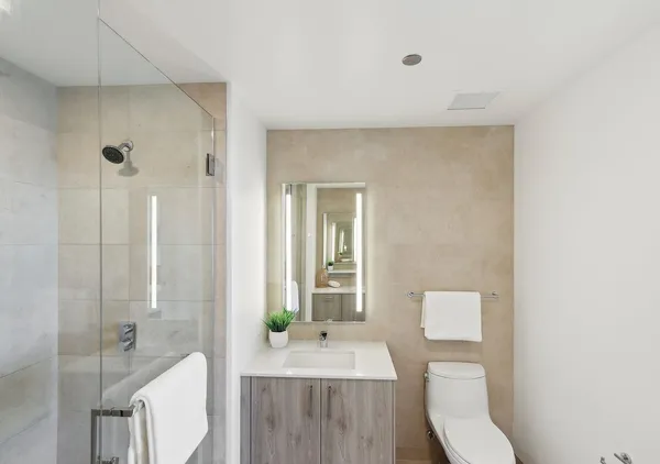 a bathroom with a sink toilet and shower