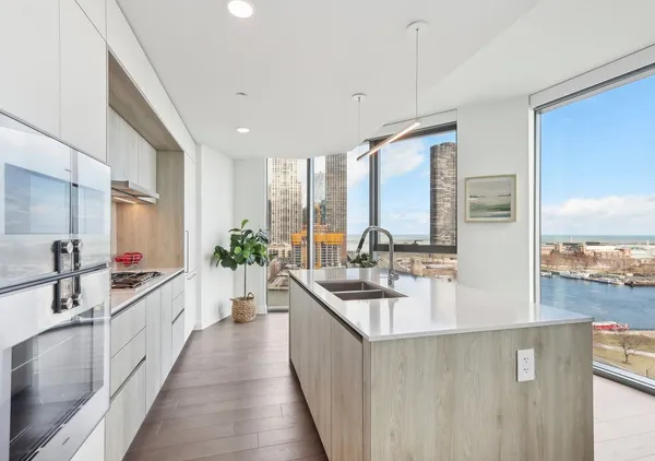 a kitchen with counter top space and wooden floor