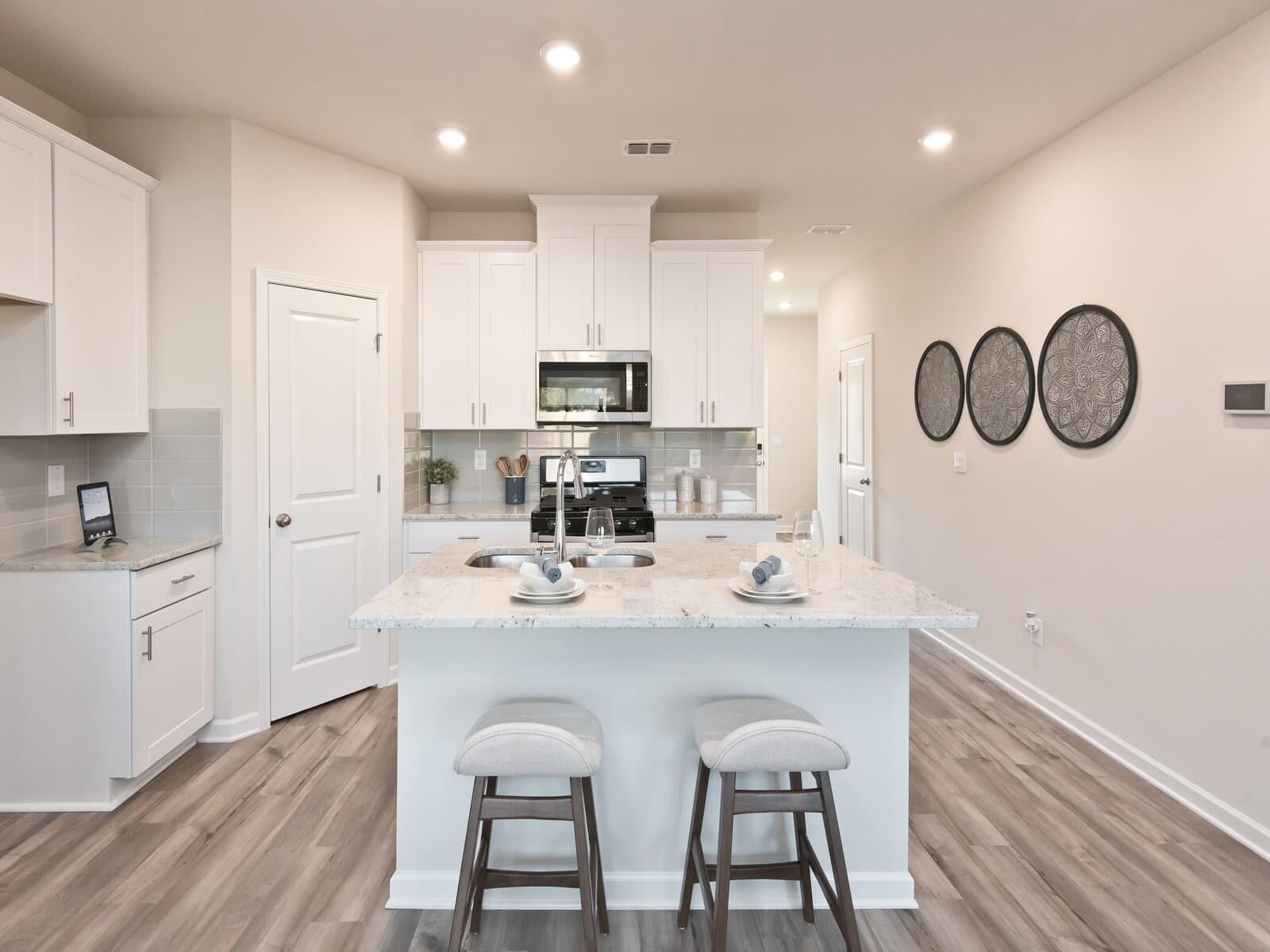 4010 County Down Avenue Kannapolis, NC 28081 - Photo 6 of 9 a kitchen with kitchen island granite countertop a sink cabinets and wooden floor