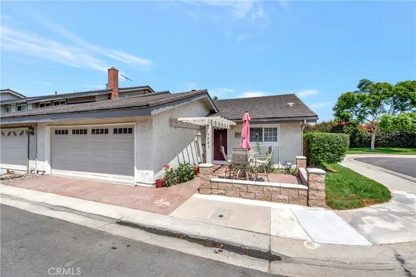 front view of house with a yard and potted plants