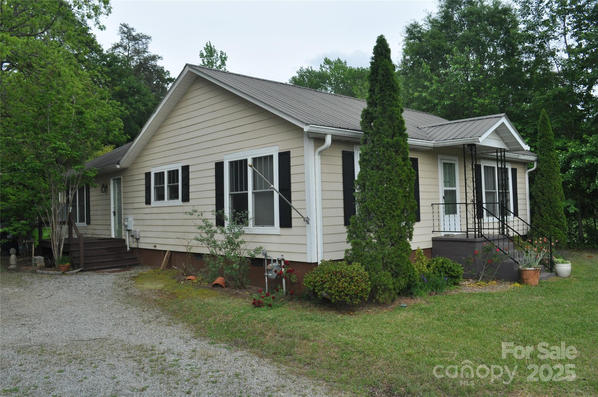 412 North Oak Avenue Landrum, SC 29356 - Photo 3 of 36 a view of a house with a yard plants and large tree