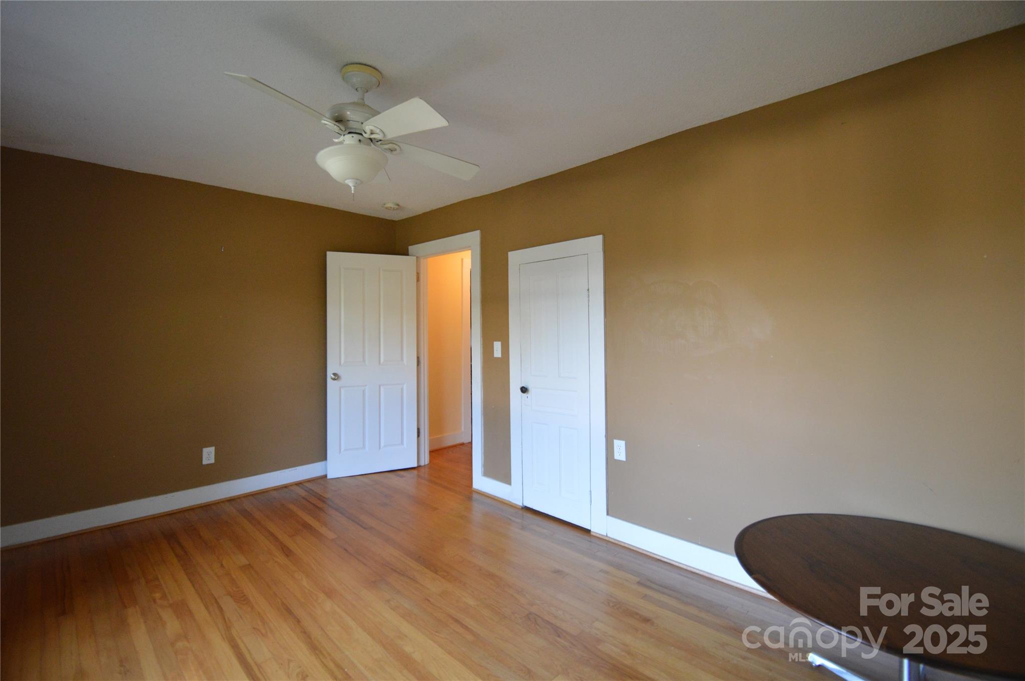 412 North Oak Avenue Landrum, SC 29356 - Photo 33 of 36 a view of an empty room with wooden floor and a ceiling fan