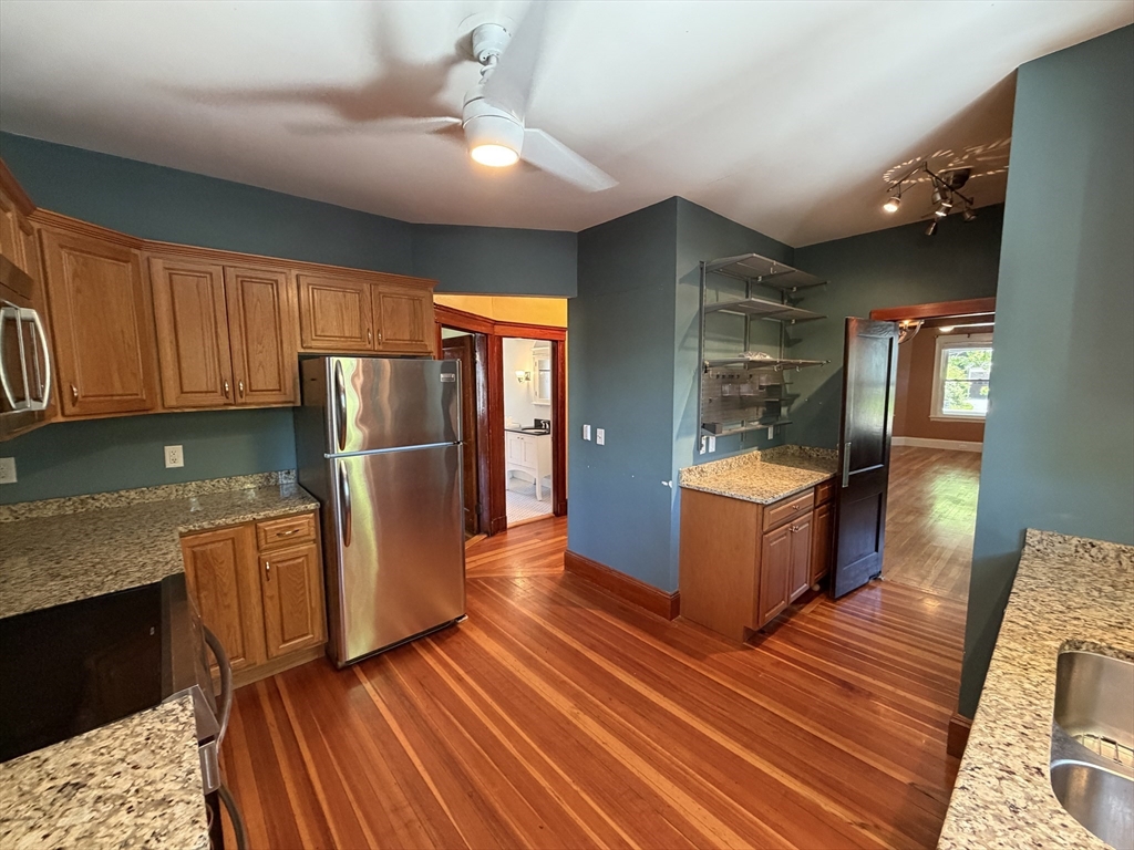12-14 Warwick Road, Unit 12 Belmont, MA 02478 - Photo 2 of 15 a kitchen with stainless steel appliances granite countertop a refrigerator a stove and a wooden floors