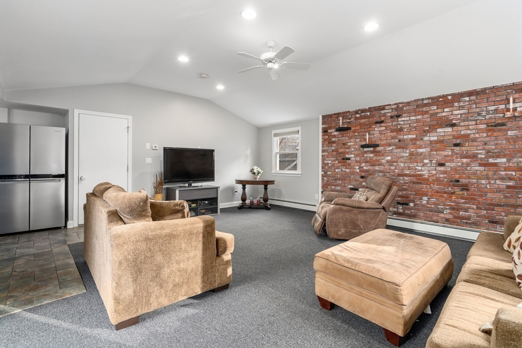 42 Gregory Road Framingham, MA 01701 - Photo 11 of 23 a living room with furniture and a flat screen tv