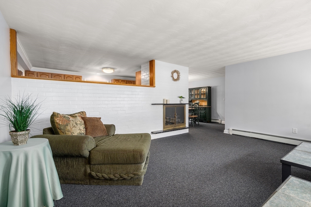 42 Gregory Road Framingham, MA 01701 - Photo 3 of 23 a living room with furniture and kitchen view