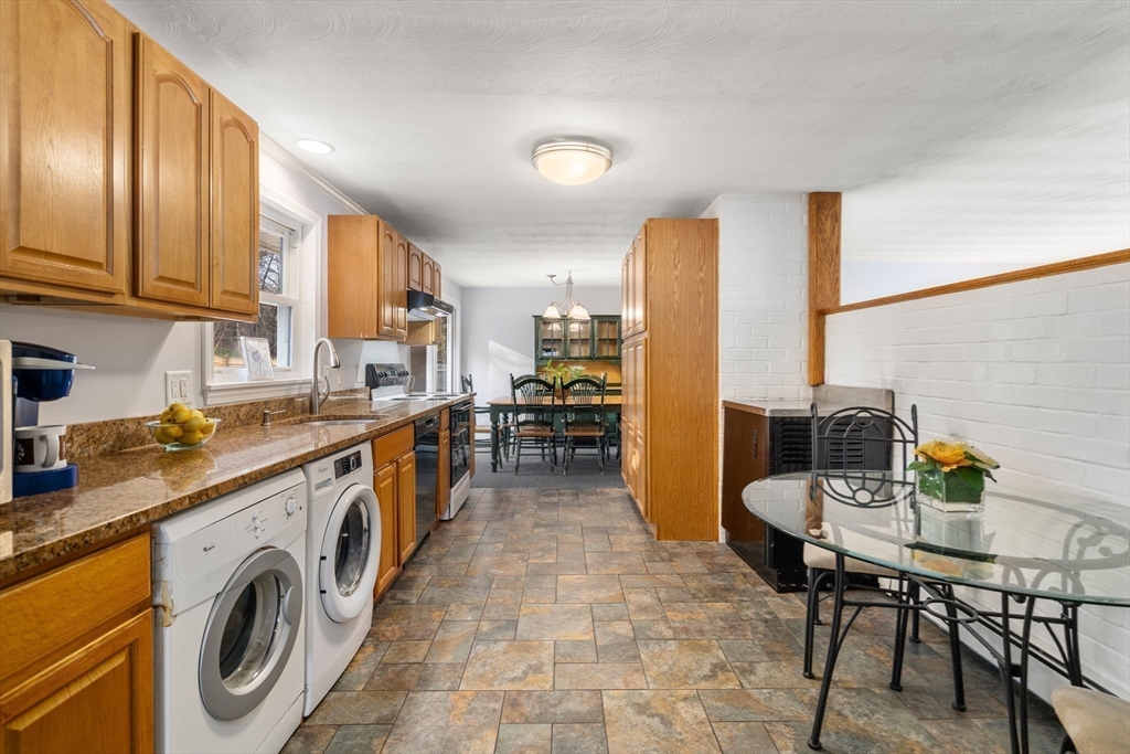 42 Gregory Road Framingham, MA 01701 - Photo 7 of 23 a kitchen with a sink a stove and chairs