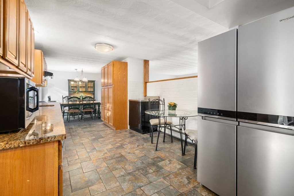 42 Gregory Road Framingham, MA 01701 - Photo 8 of 23 a kitchen with stainless steel appliances granite countertop a refrigerator and a stove