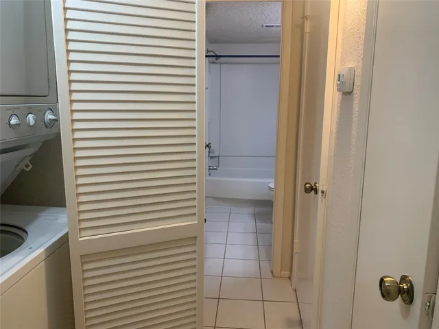 a kitchen with a refrigerator and a sink