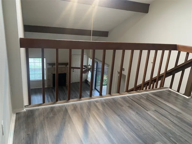a view of a room with wooden floor