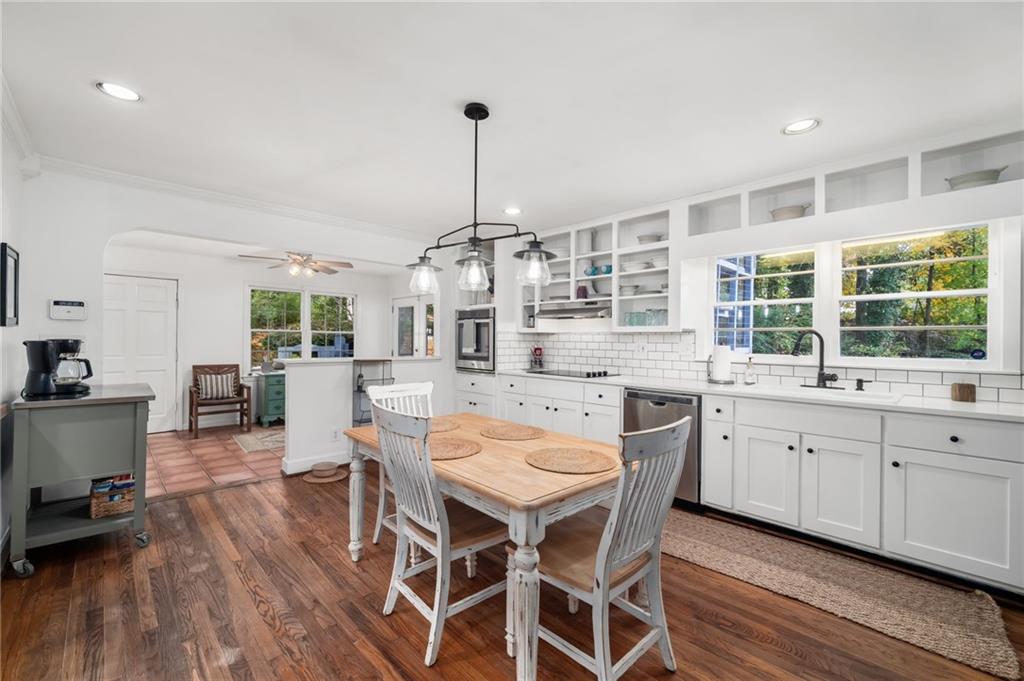 866 Buckner Road Mableton, GA 30126 - Photo 12 of 57 a kitchen with a dining table chairs wooden floor and appliances