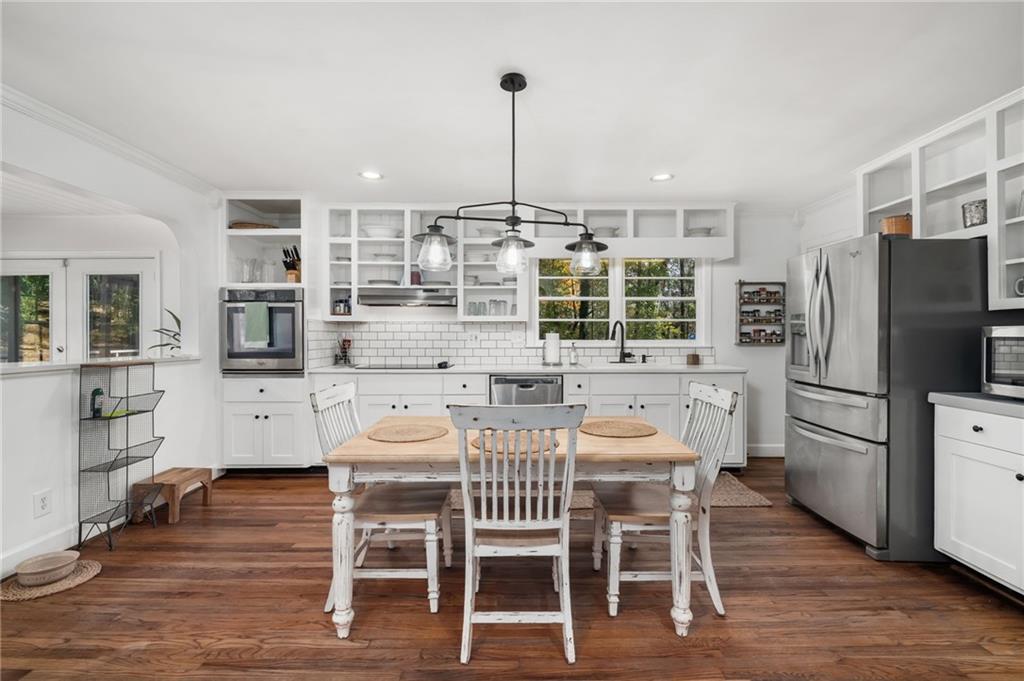 866 Buckner Road Mableton, GA 30126 - Photo 13 of 57 a kitchen with stainless steel appliances granite countertop a dining table chairs refrigerator and microwave