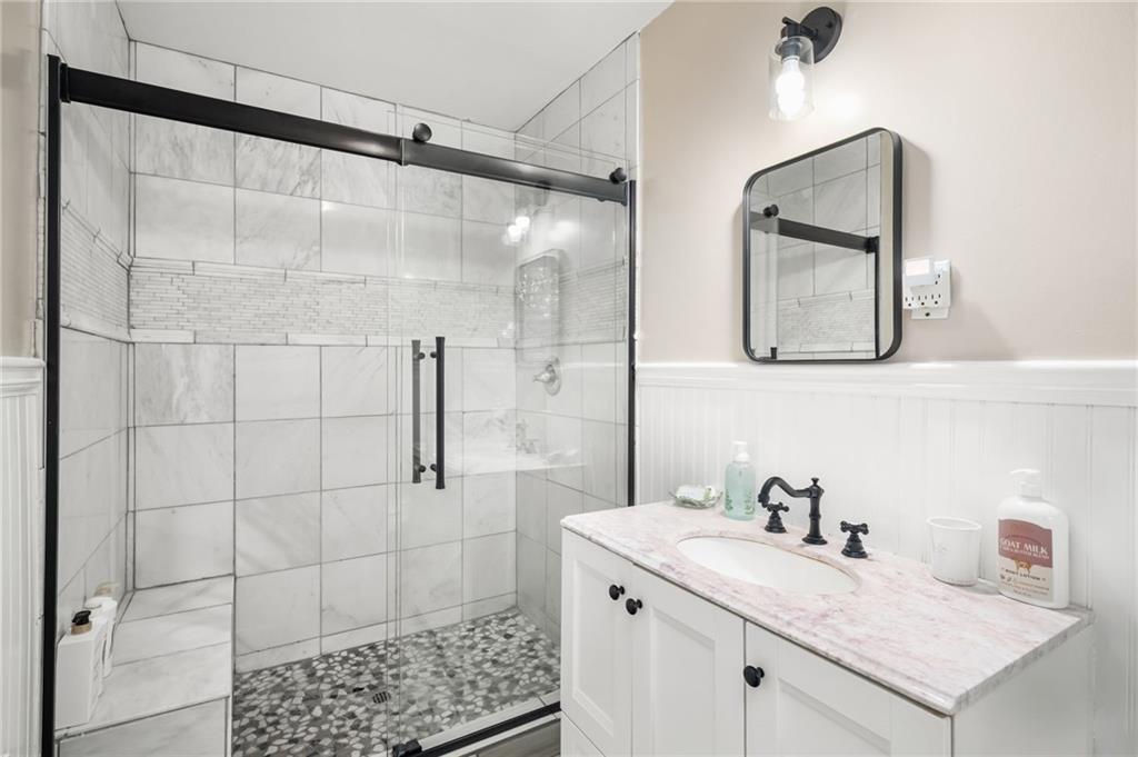 866 Buckner Road Mableton, GA 30126 - Photo 21 of 57 a bathroom with a sink vanity and shower