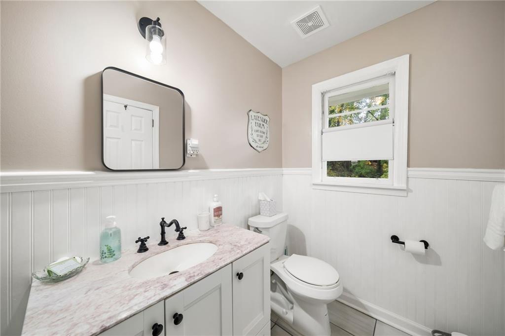 866 Buckner Road Mableton, GA 30126 - Photo 22 of 57 a bathroom with a granite countertop toilet sink and mirror