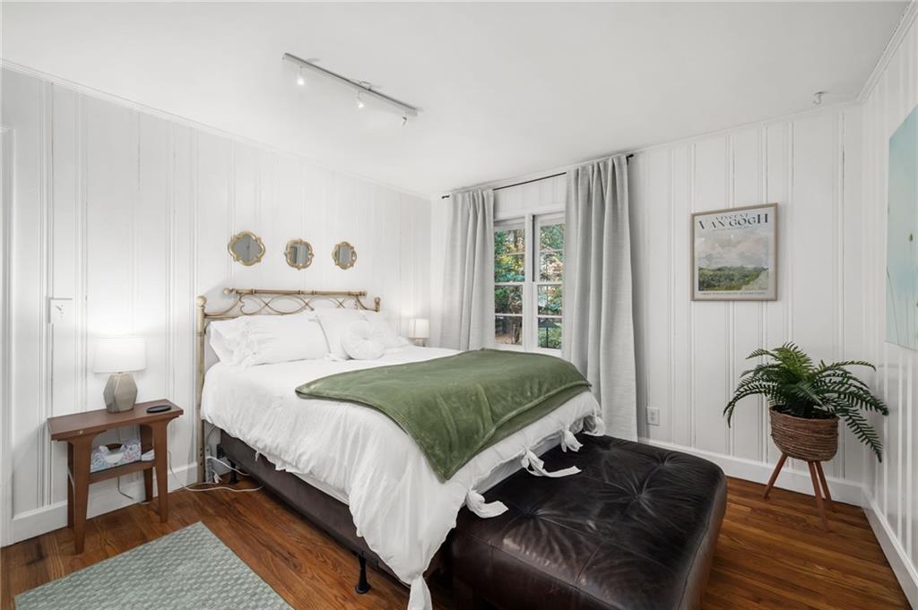 866 Buckner Road Mableton, GA 30126 - Photo 23 of 57 a bedroom with a bed lamp and a potted plant