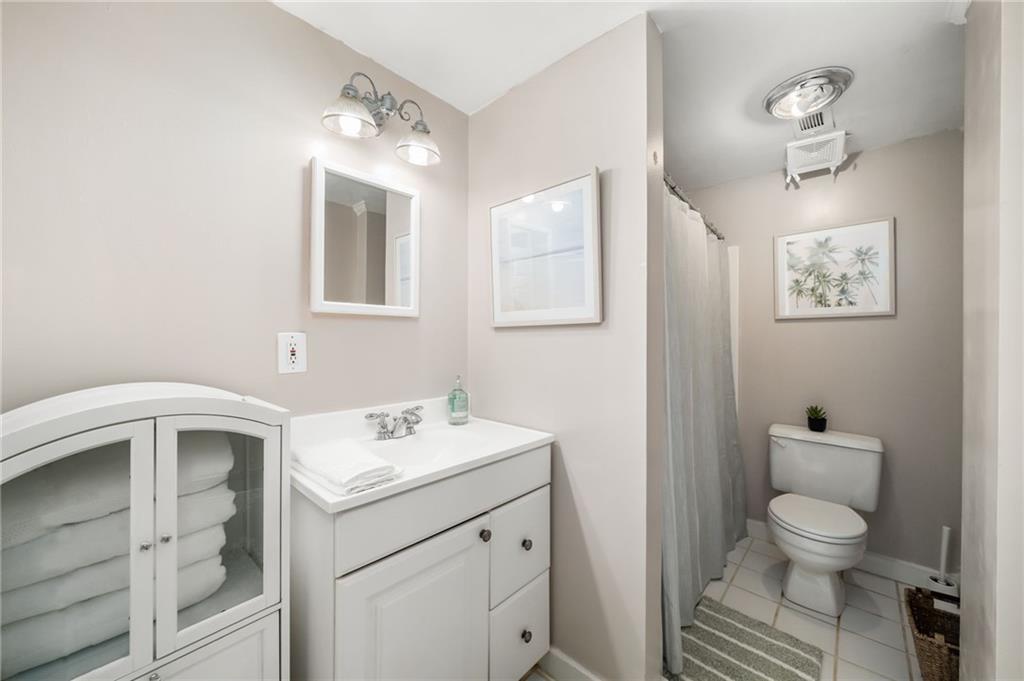 866 Buckner Road Mableton, GA 30126 - Photo 33 of 57 a bathroom with a toilet sink and mirror