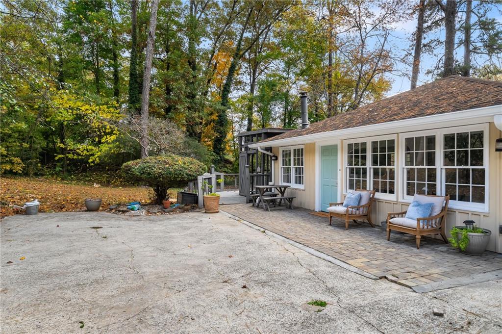 866 Buckner Road Mableton, GA 30126 - Photo 43 of 57 a view of a house with backyard sitting area and porch