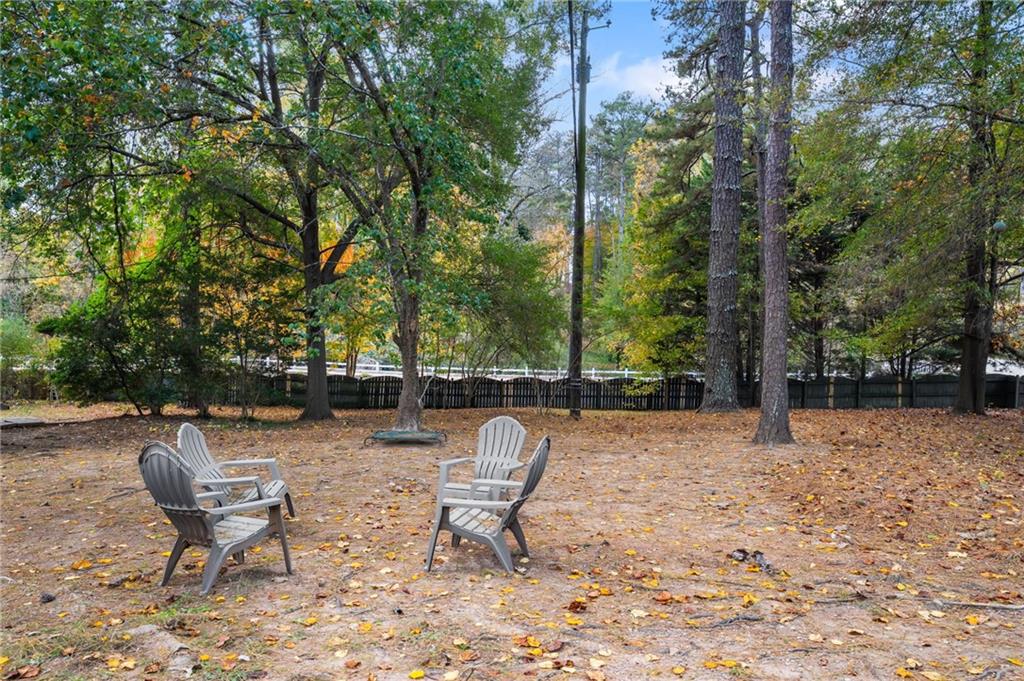 866 Buckner Road Mableton, GA 30126 - Photo 44 of 57 a backyard of a house with table and chairs