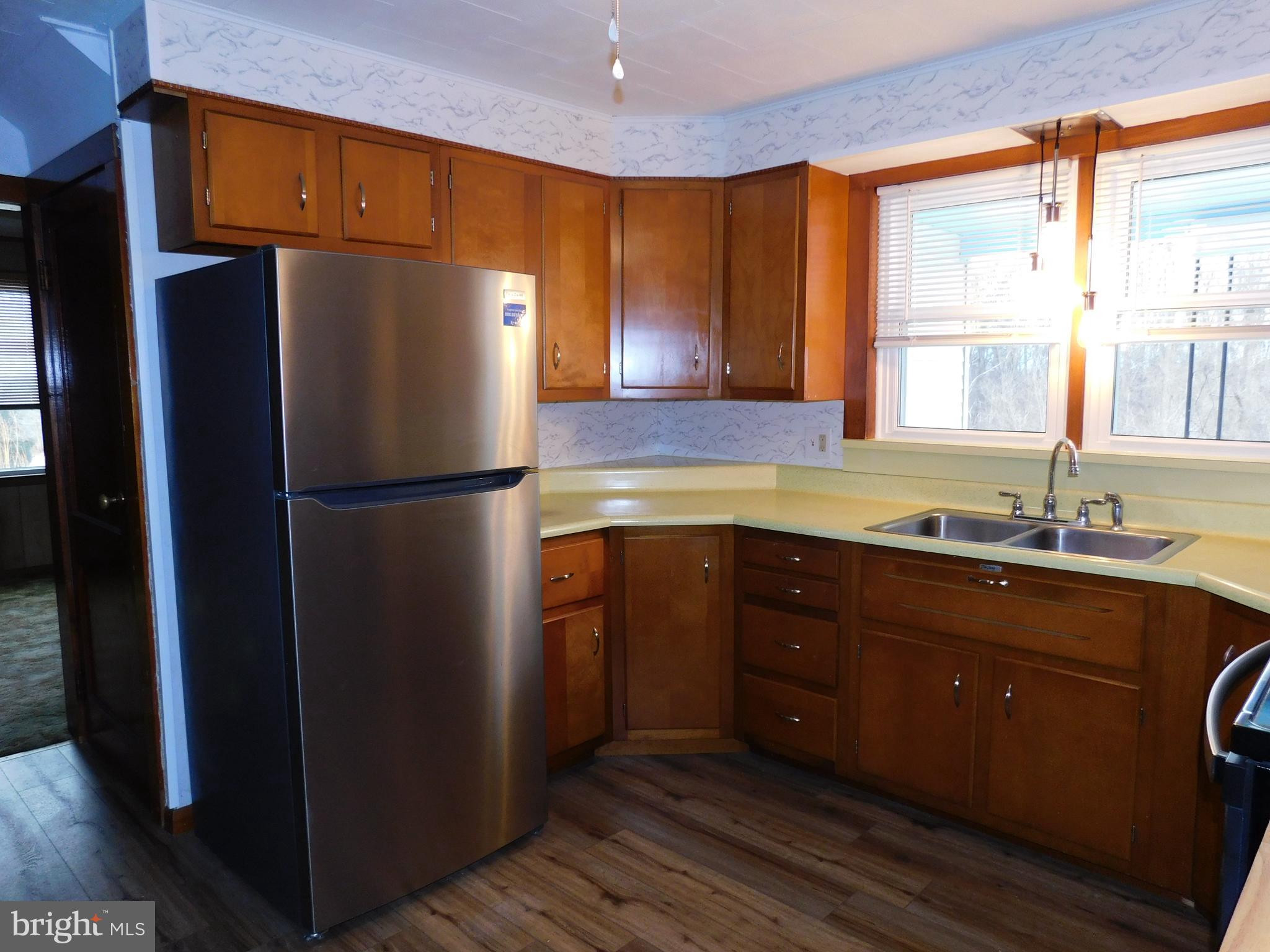 122 Loop Road Lewistown, PA 17044 - Photo 6 of 41 a kitchen with a refrigerator and a sink