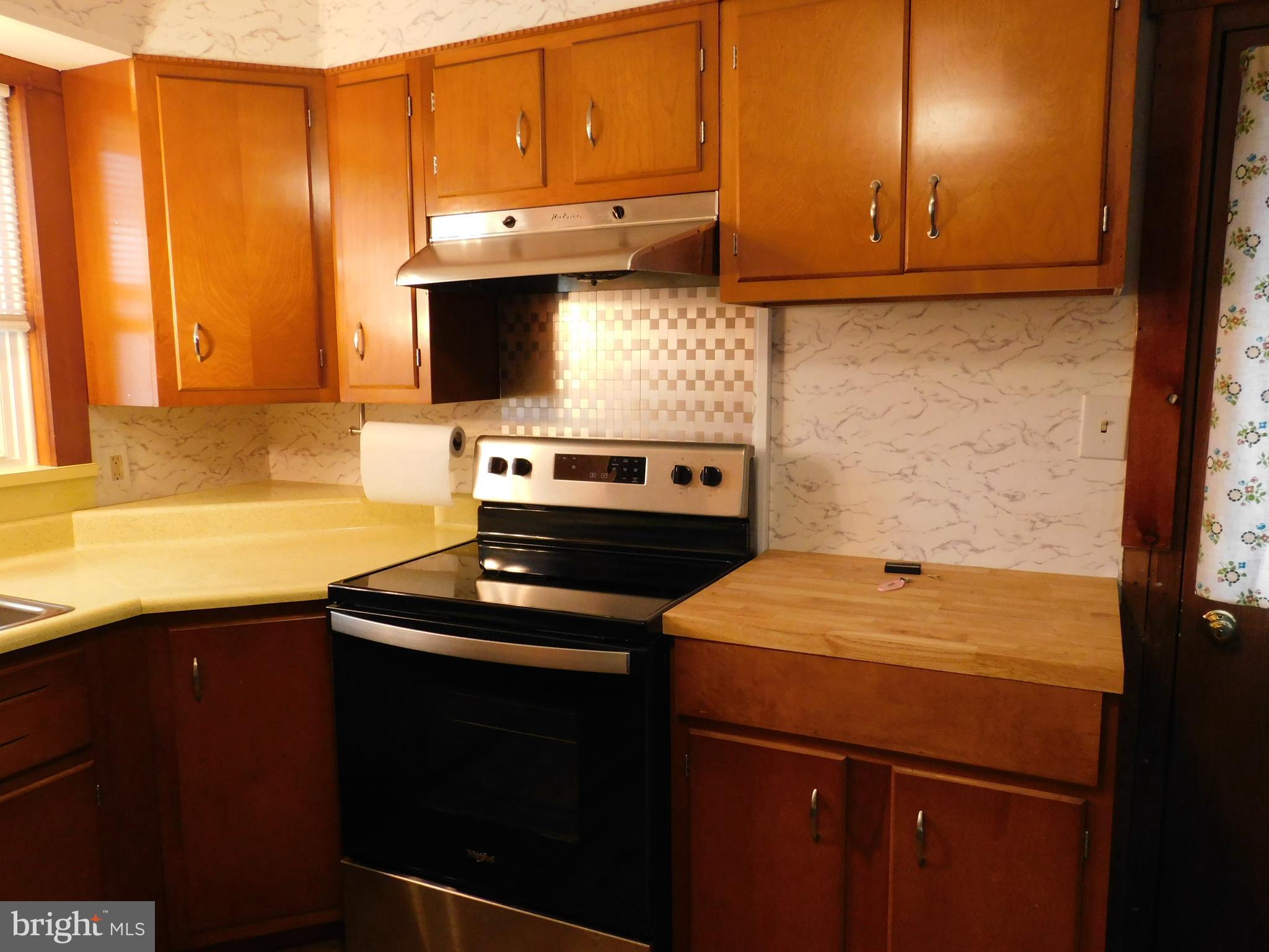 122 Loop Road Lewistown, PA 17044 - Photo 7 of 41 a kitchen with stainless steel appliances a stove a microwave and a sink