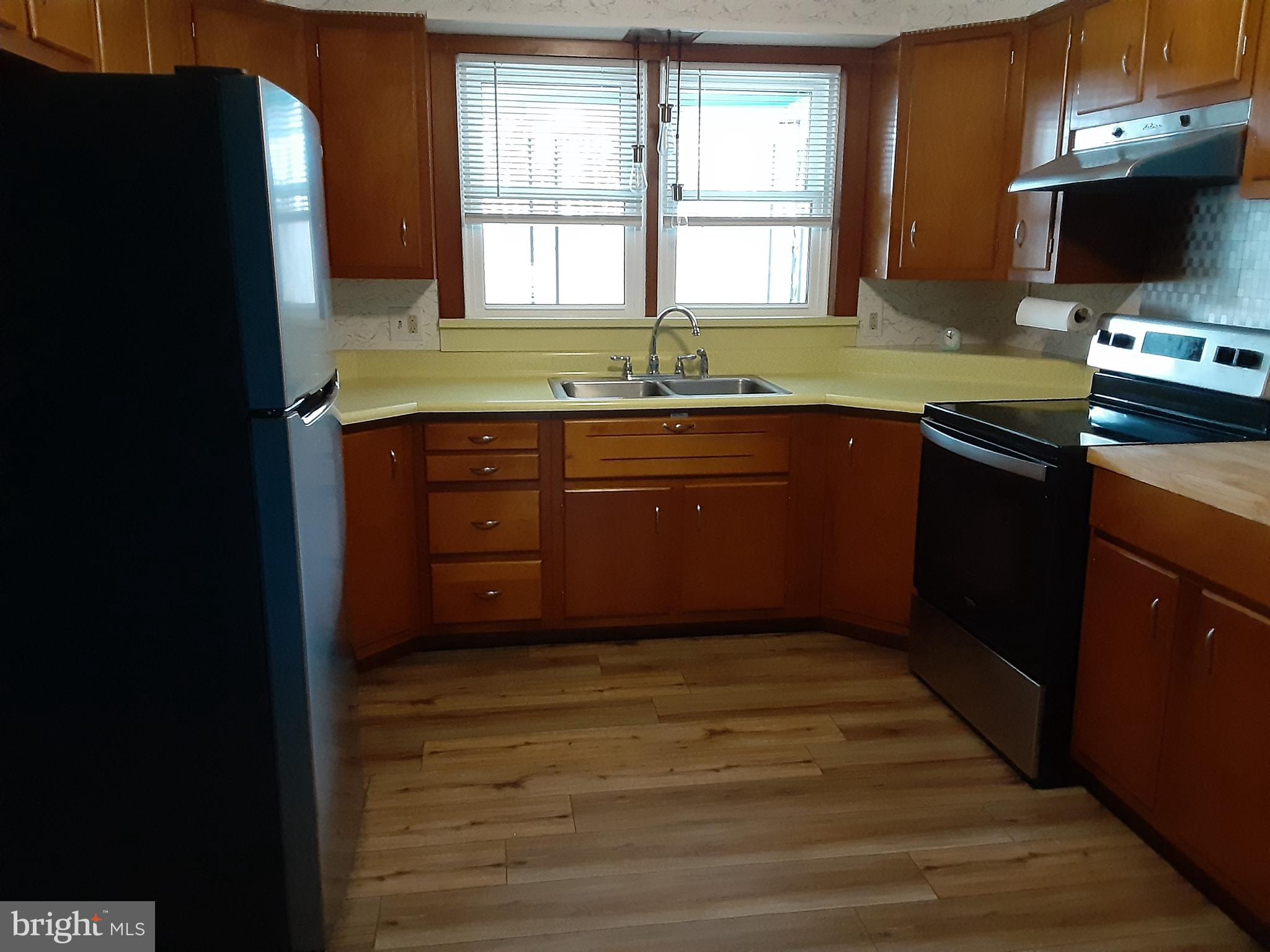 122 Loop Road Lewistown, PA 17044 - Photo 9 of 41 a kitchen with a refrigerator and a sink