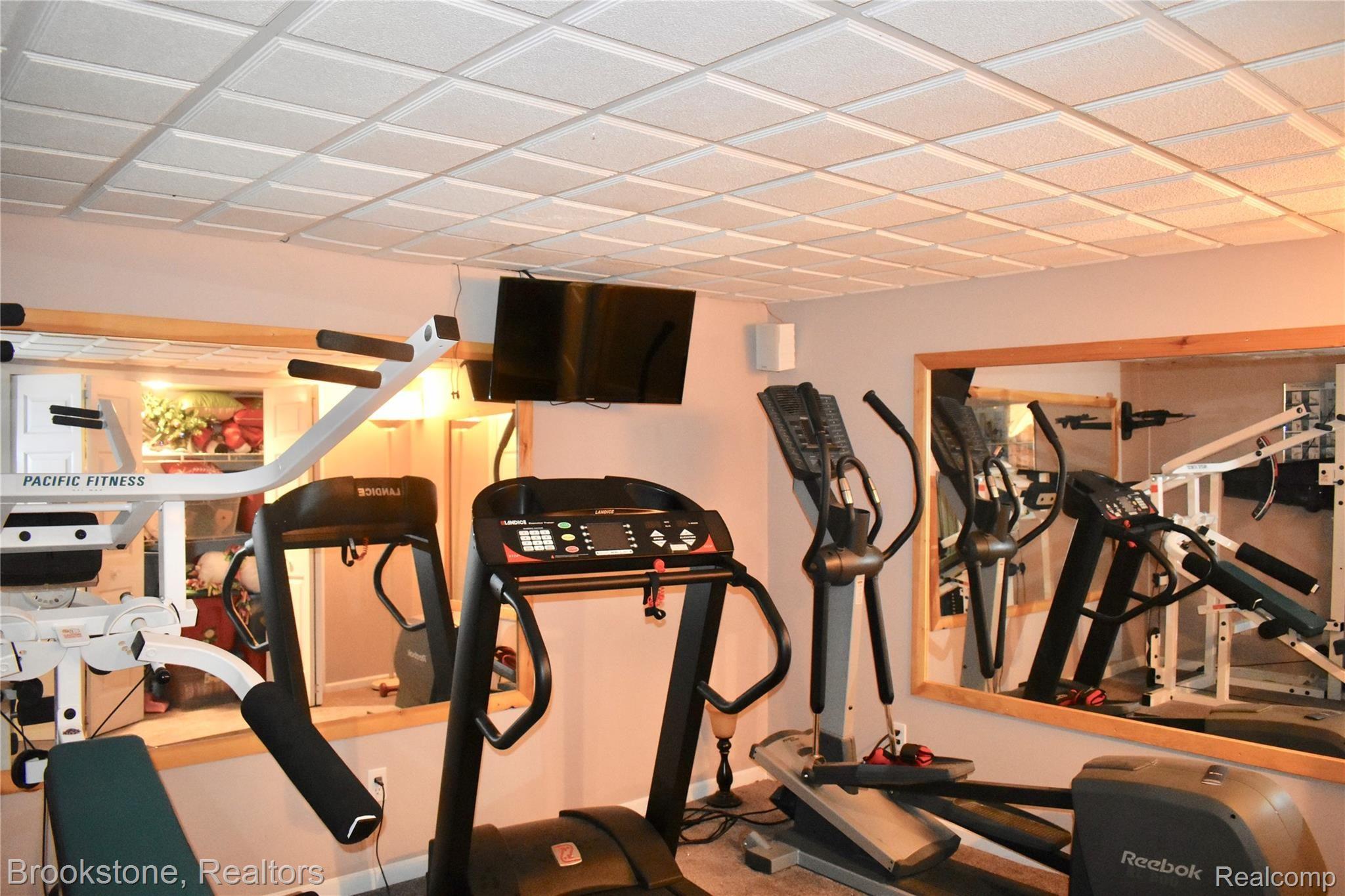 405 Baldwin Ridge Oxford, MI 48371 - Photo 46 of 54 THE FITNESS ROOM IS LOCATED A FEW STEPS FROM THE BASEMENT A BATH SO AFTER A "WORKOUT YOU HAVE THE OPPORTUNITY TO SHOWER