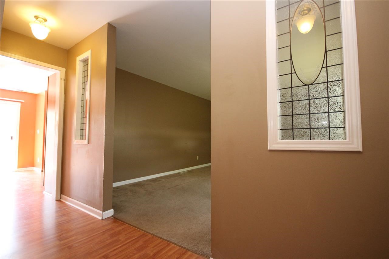 405 Pembroke Road Southwest Poplar Grove, IL 61065 - Photo 3 of 21 an empty room with wooden floor and windows
