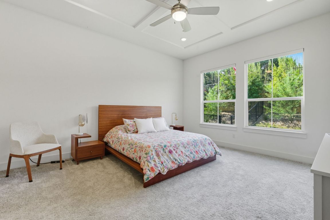 101 Cartwheel Bend, Unit 52 Austin, TX 78738 - Photo 13 of 31 a bedroom with a bed and a chair