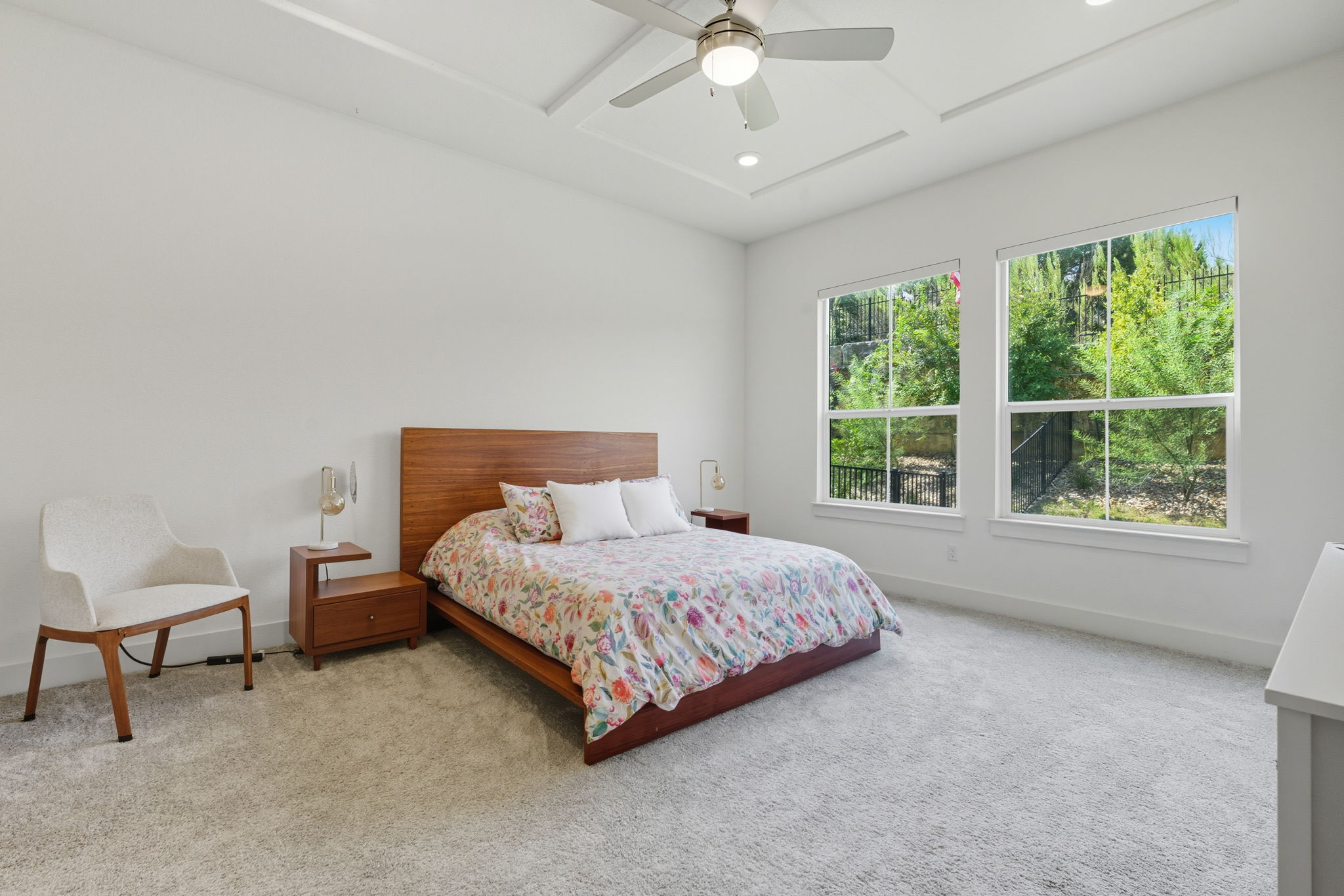 101 Cartwheel Bend, Unit 52 Austin, TX 78738 - Photo 13 of 29 a bedroom with a bed and a chair