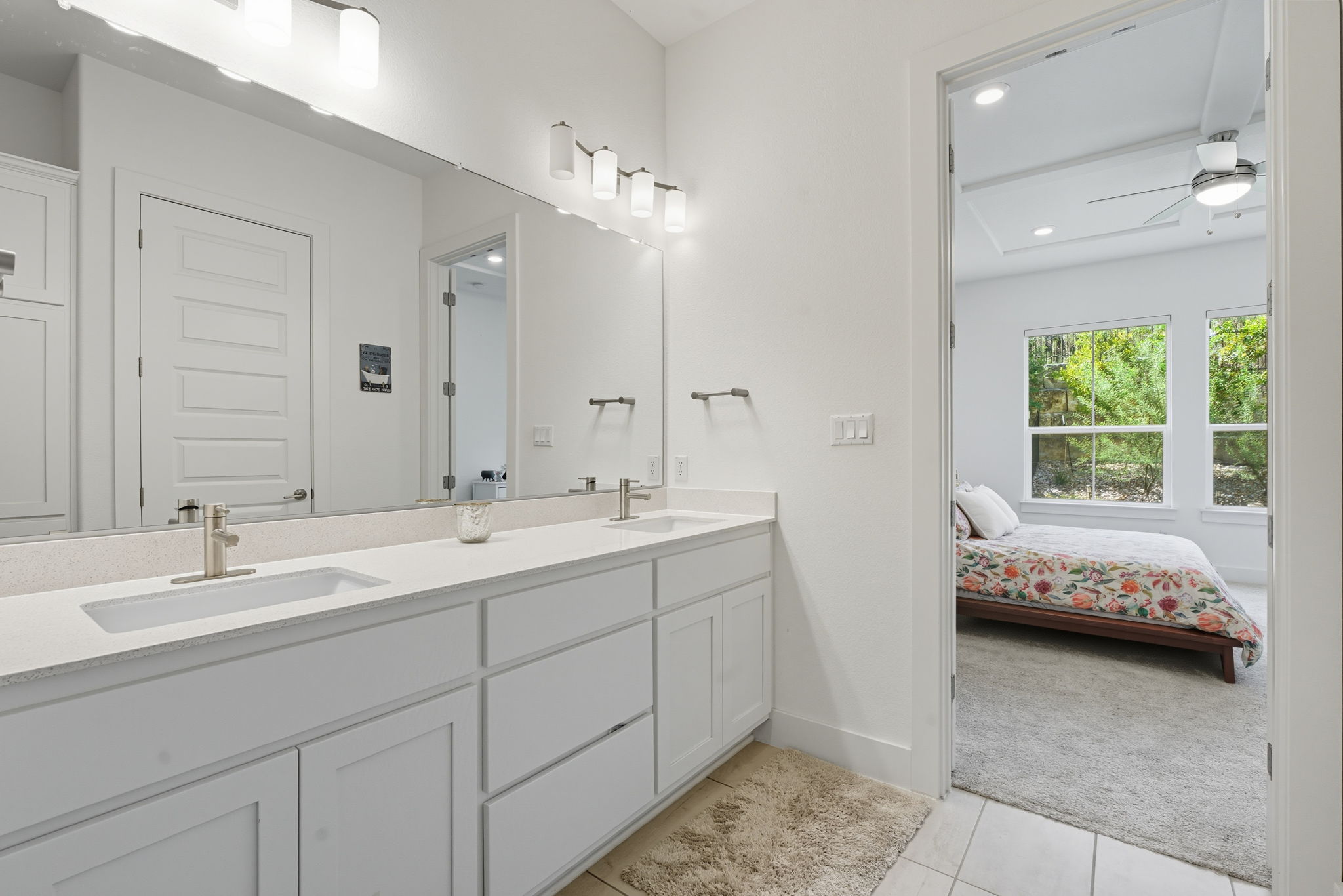 101 Cartwheel Bend, Unit 52 Austin, TX 78738 - Photo 15 of 29 a en suite bathroom with a double vanity sink a mirror and a