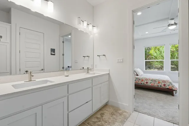a en suite bathroom with double sink and a mirror