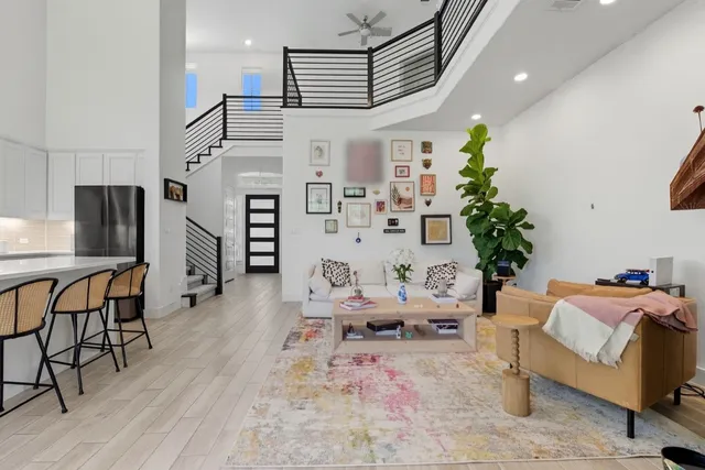 a living room with furniture and a chandelier