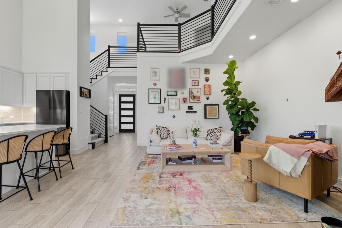 101 Cartwheel Bend, Unit 52 Austin, TX 78738 - Photo 2 of 31 a living room with furniture and a chandelier