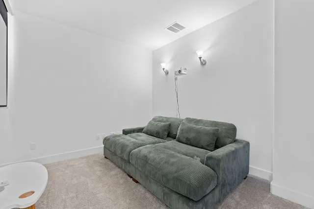 a living room with furniture a couch and a potted plant