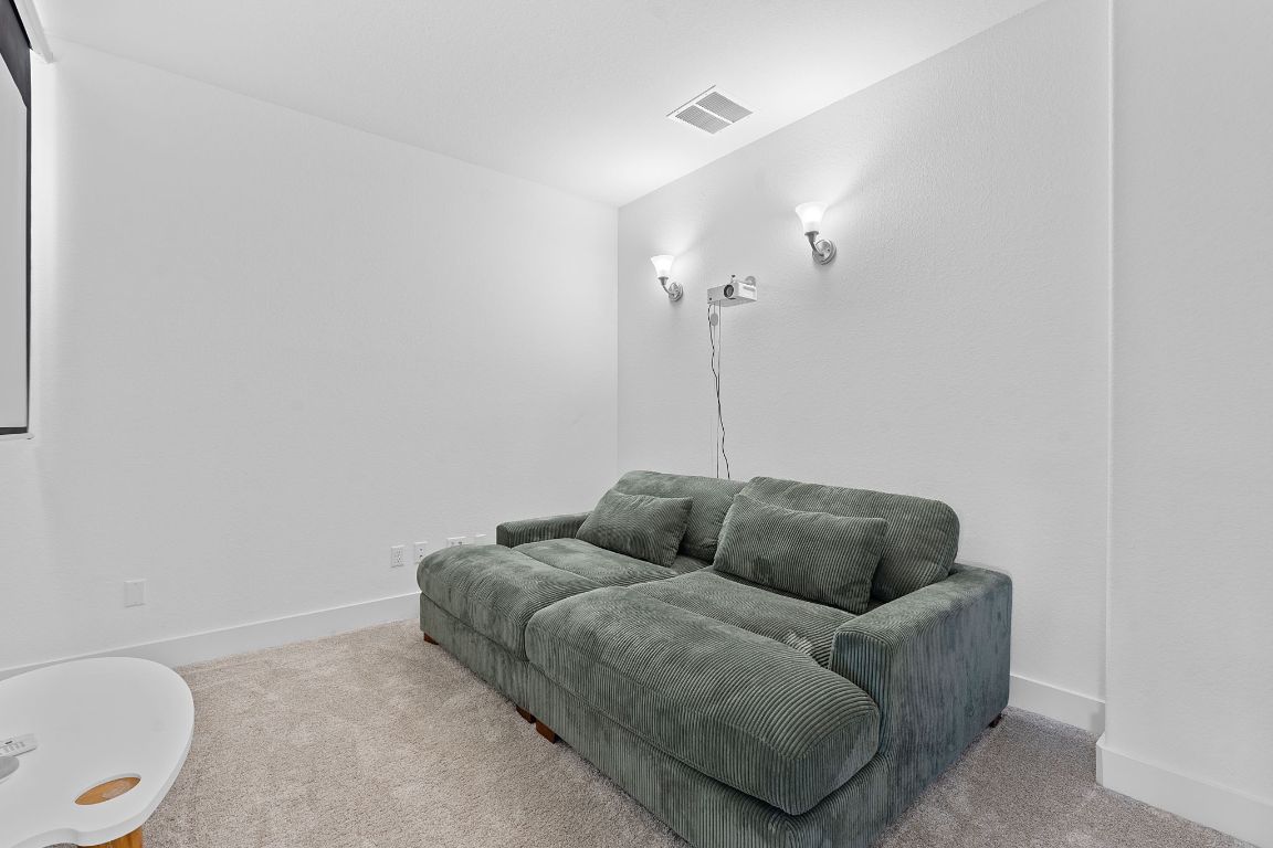 101 Cartwheel Bend, Unit 52 Austin, TX 78738 - Photo 22 of 31 a living room with furniture a couch and a potted plant