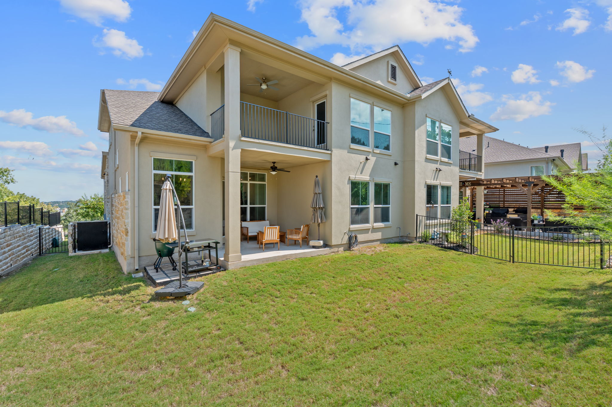 101 Cartwheel Bend, Unit 52 Austin, TX 78738 - Photo 25 of 29 a view of a house with a yard and sitting area