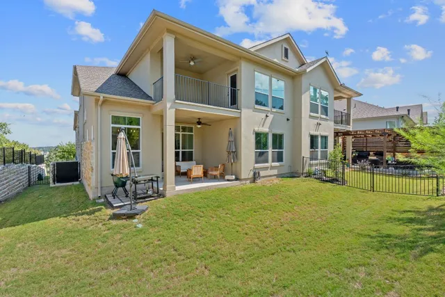 a view of a house with a yard and sitting area