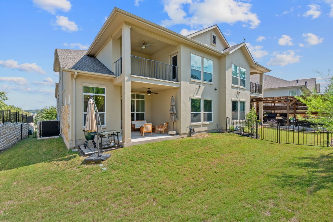 101 Cartwheel Bend, Unit 52 Austin, TX 78738 - Photo 27 of 31 a view of a house with a yard and sitting area