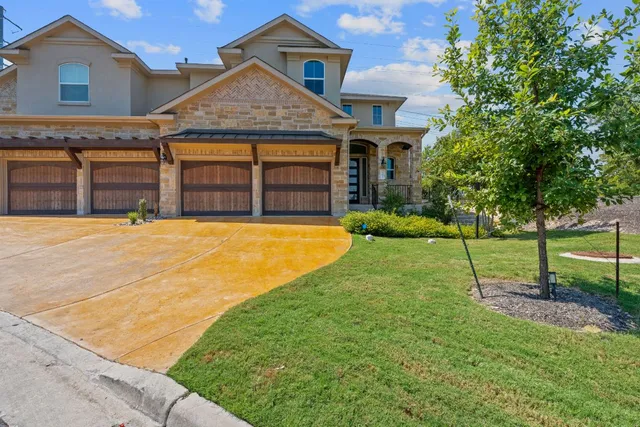 a view of a house with a yard and tree s
