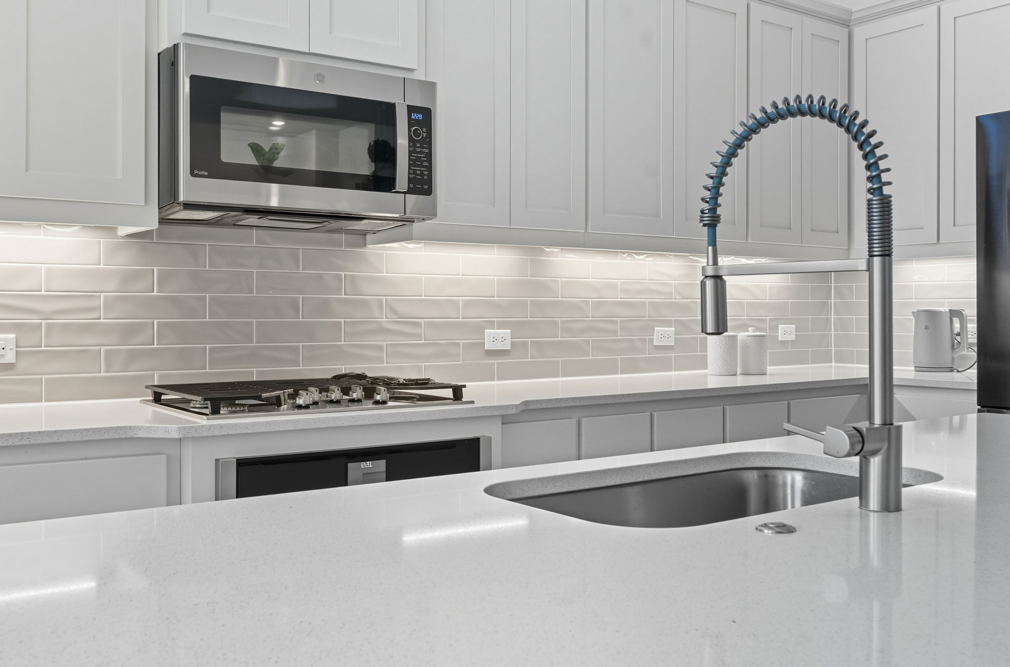 101 Cartwheel Bend, Unit 52 Austin, TX 78738 - Photo 4 of 29 a kitchen with a stove a sink and a microwave