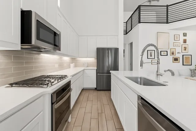 a kitchen that has a sink and a stove