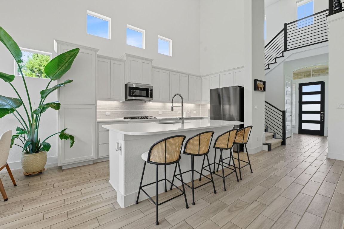 101 Cartwheel Bend, Unit 52 Austin, TX 78738 - Photo 9 of 31 a dining room with furniture and a kitchen view